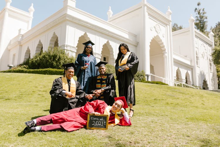 Newly Graduate Students Wearing Toga While Looking At The Camera