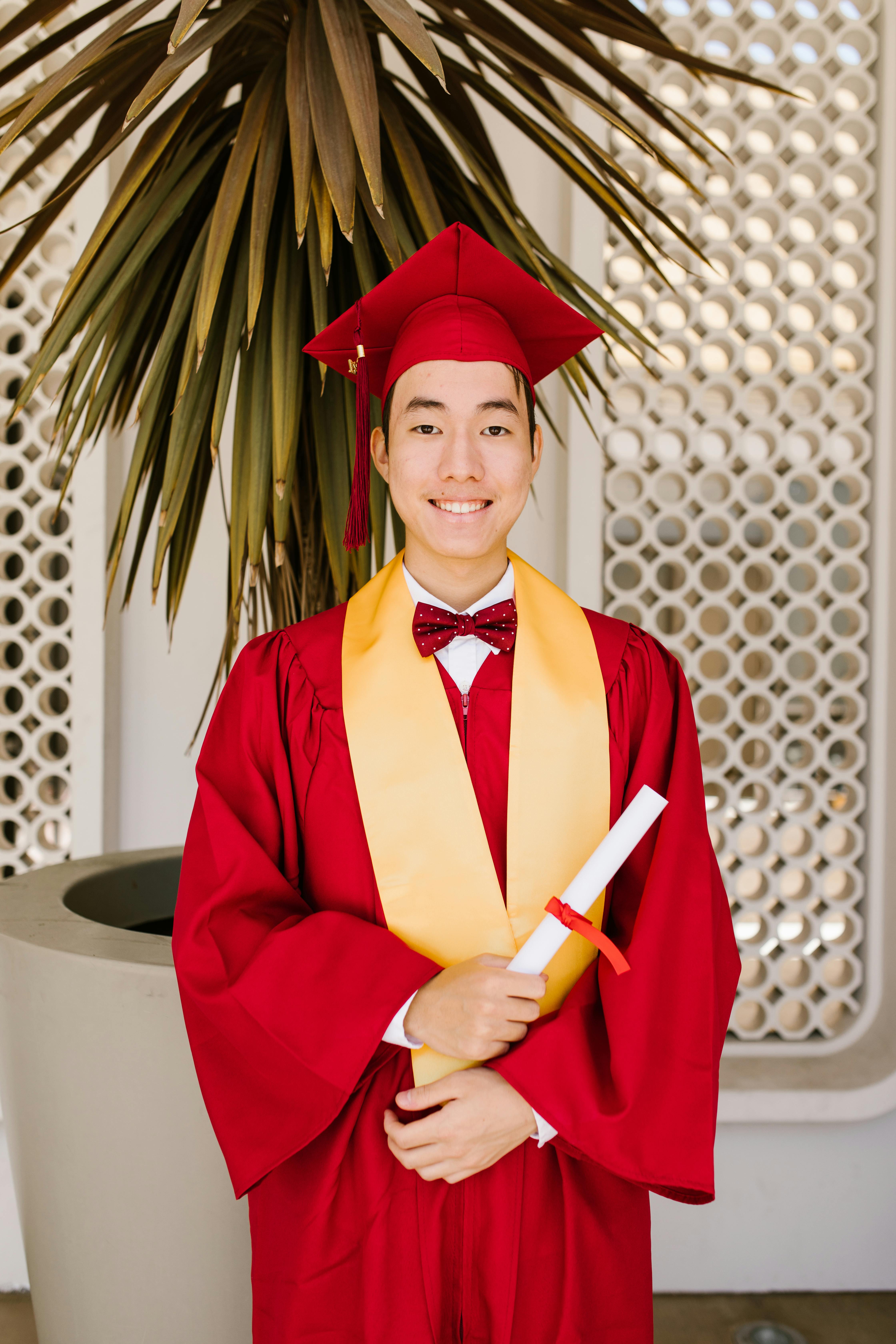 Asian Graduate man in cap and gown smile Cross Arm looking Away with  Confident emotional so proud and happiness in Graduation day,Isolated on  white Background,Education Graduation Concept Stock Photo | Adobe Stock