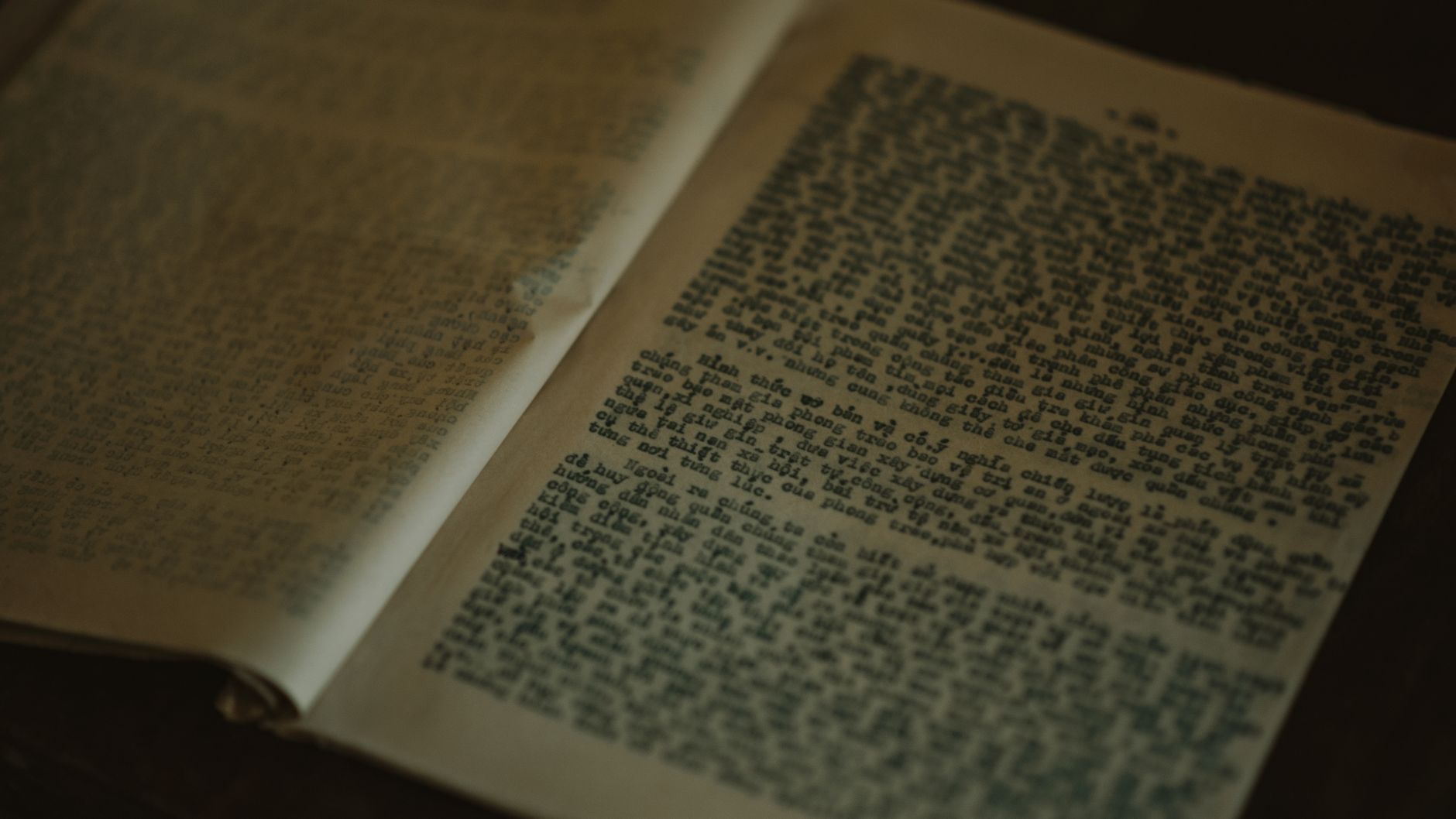Close-up of vintage book pages with weathered text, creating a historical ambiance.