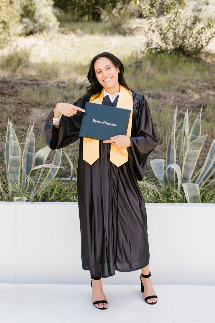 Woman In Black Dress Holding A Diploma