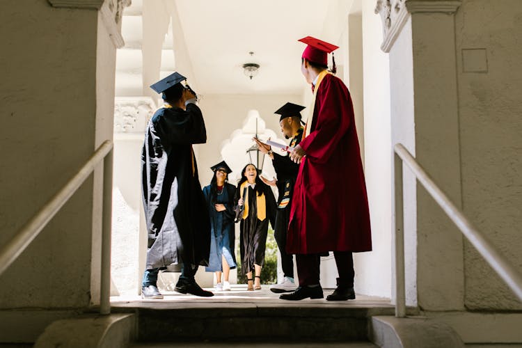 Graduating Students Walking Down The University Hallway