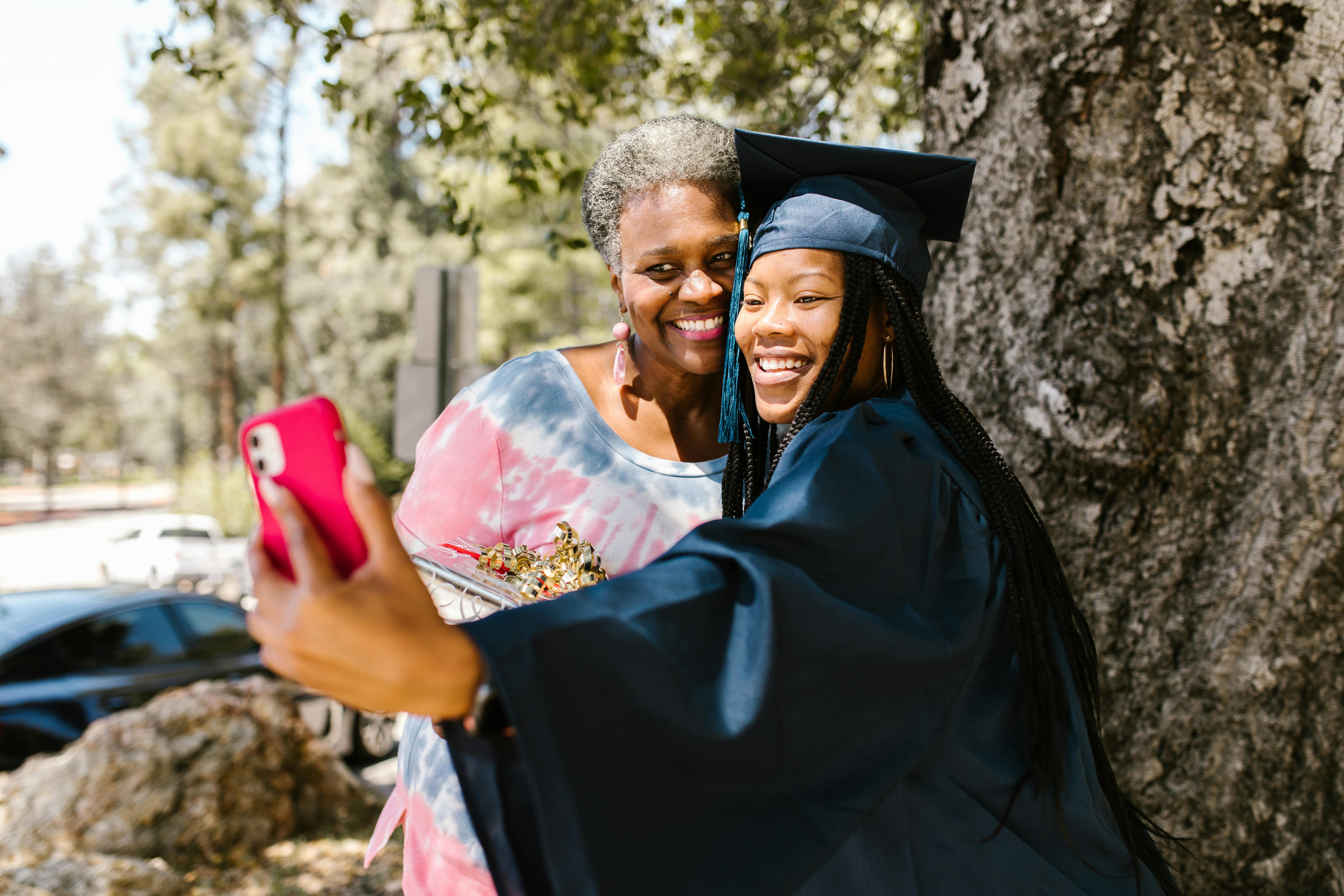 women taking picture using a smartphone