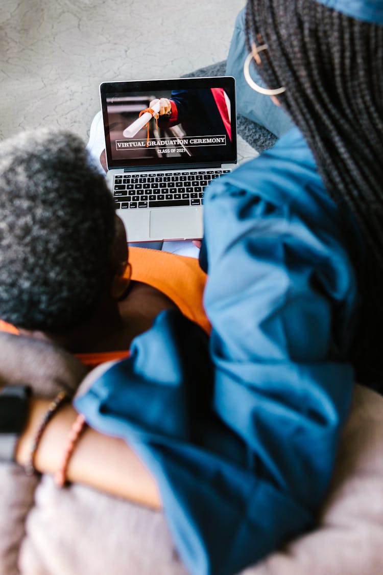 Graduate Watching Virtual Graduation With Grandmother