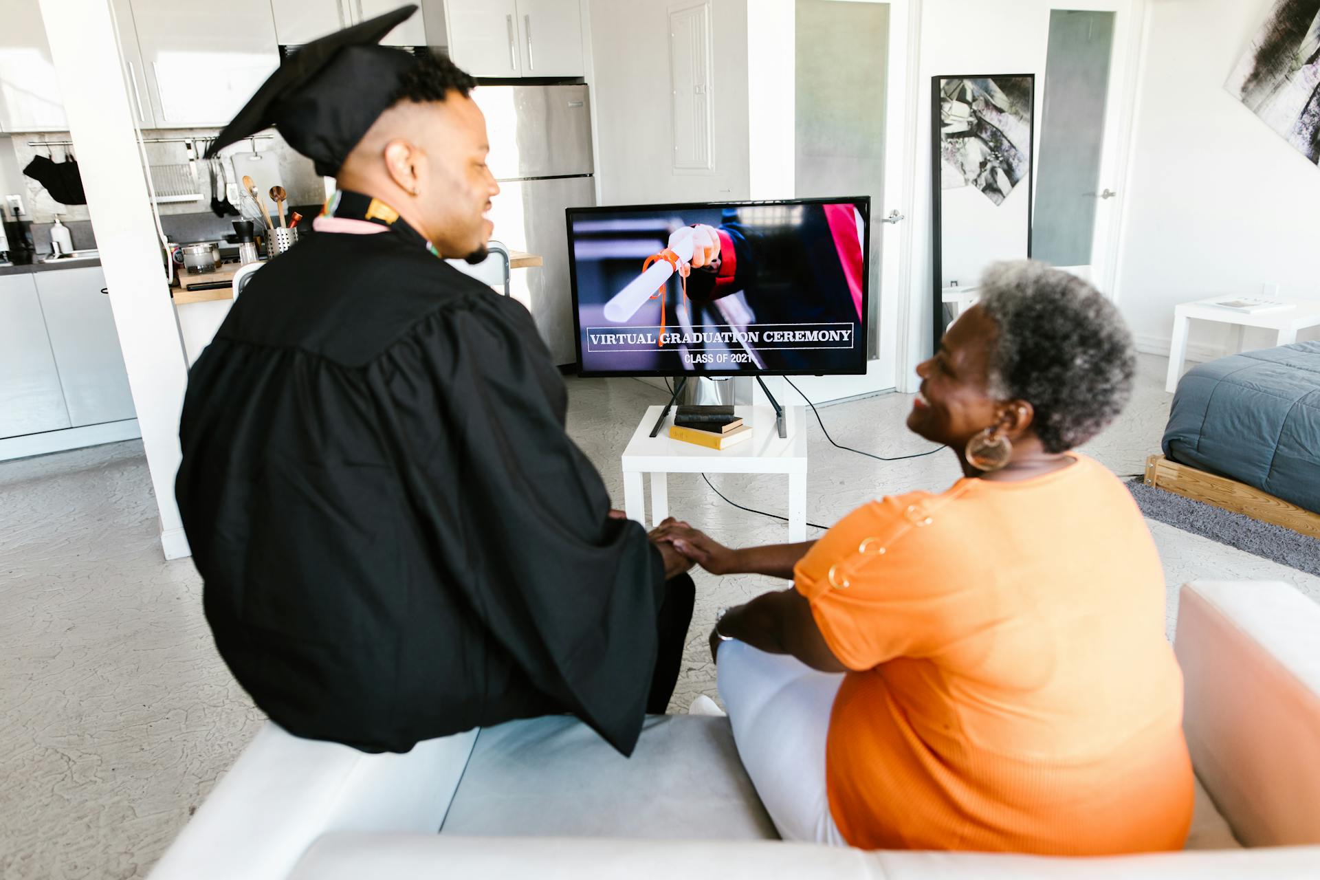 Graduating Student Watching the Online Ceremony with his Grandmother