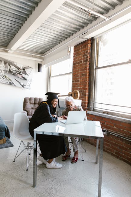 A graduate and elderly family member share a joyful moment indoors. - My Top Tips for New Graduates Writing Their First CV.