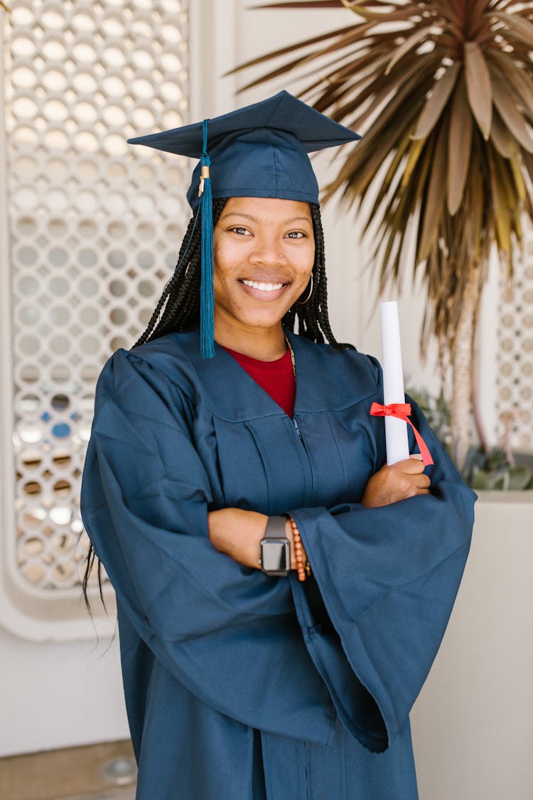 A Fresh Graduate Woman In Blue Academic Gown 