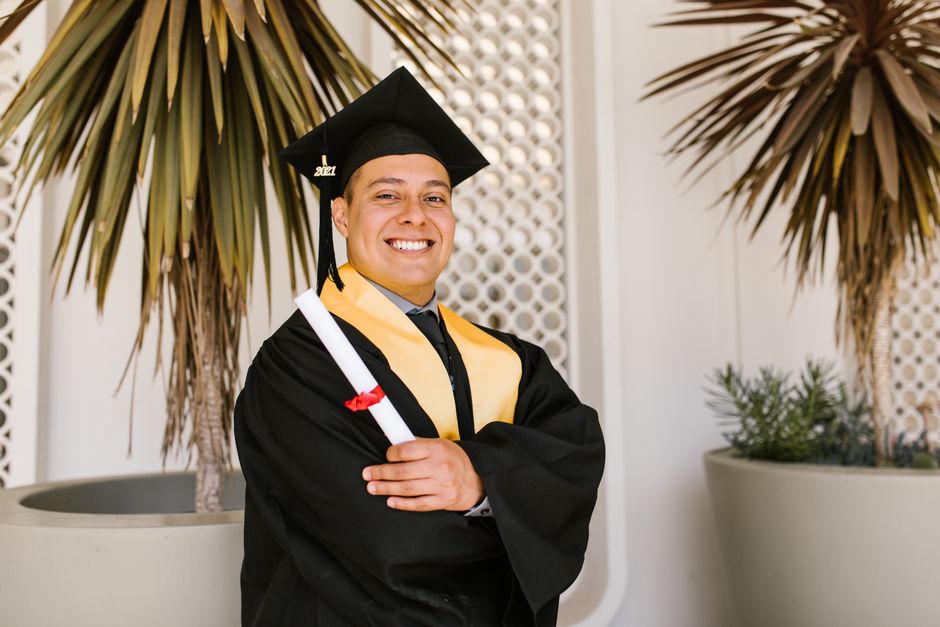 A joyful graduate holding a diploma, symbolizing success and accomplishment. A joyful graduate holding a diploma, symbolizing success and accomplishment.