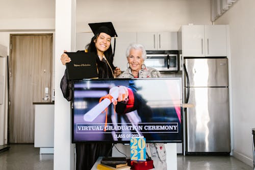 Free Elderly Woman and Student Standing Near the  Flat Screen Television Stock Photo