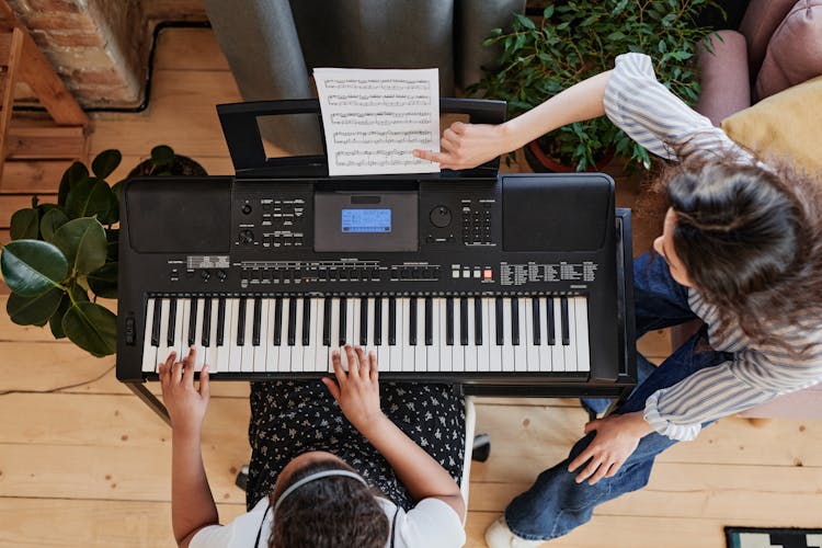 A Woman Teaching A Piano Lessons