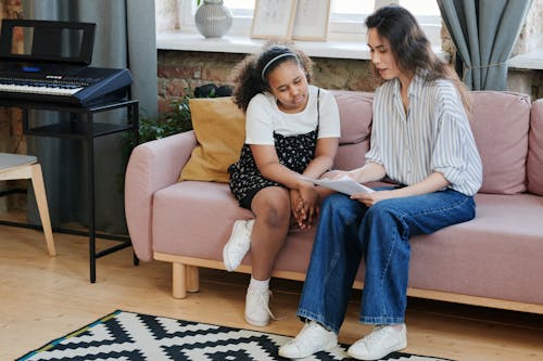 Woman Talking to Girl in Living Room with Synthesizer