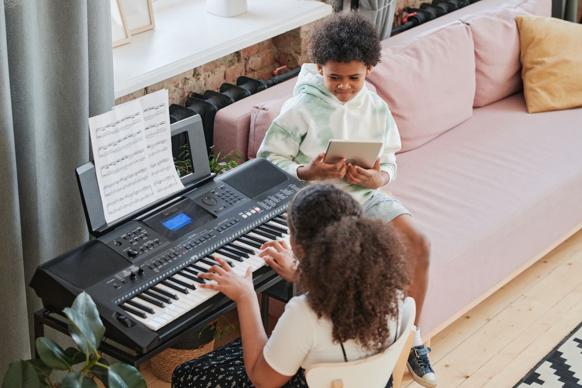 Young girl playing piano at home