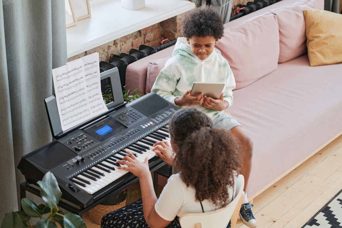 Free A Young Girl Playing Piano at Home Stock Photo