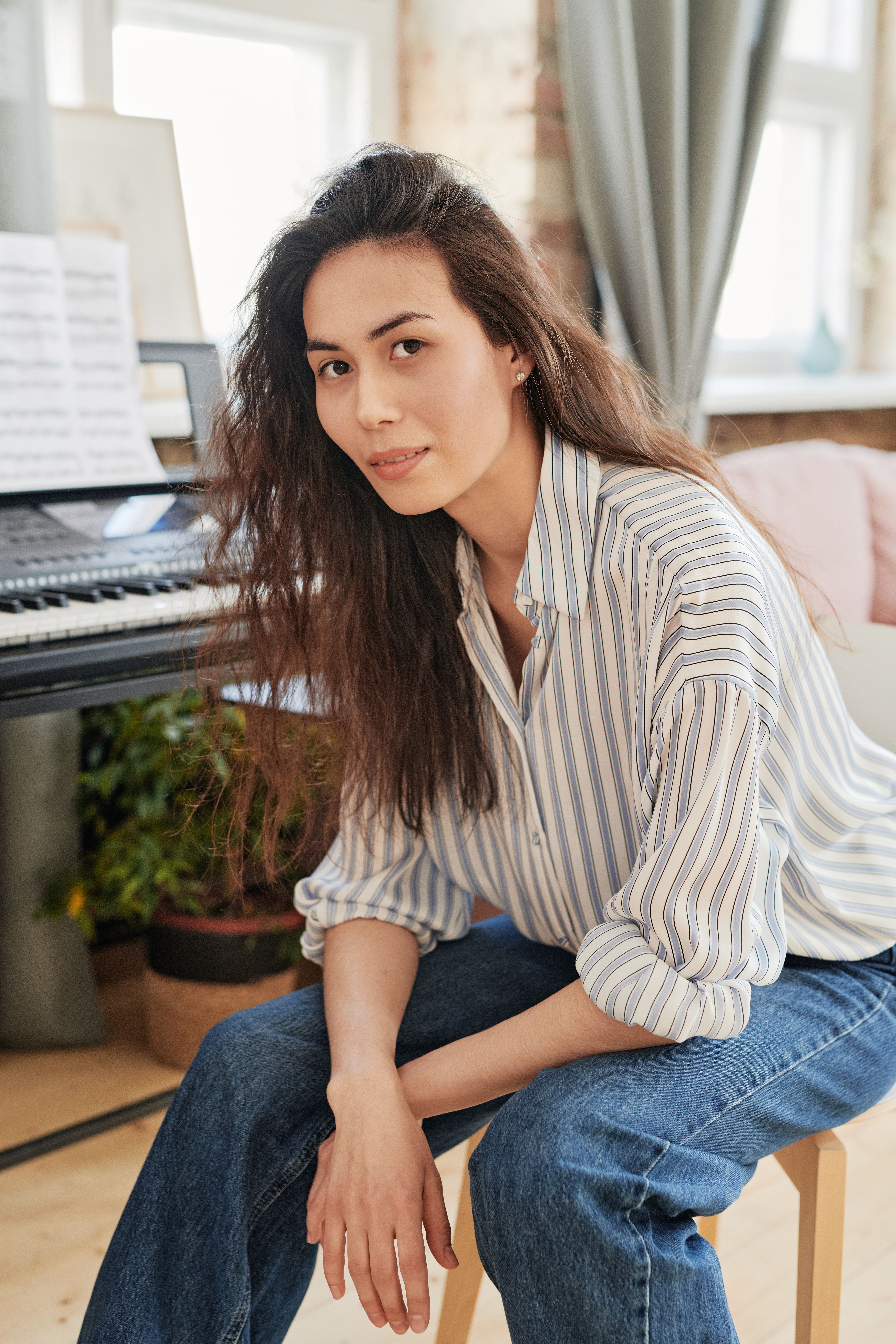Woman in a Blue and White Striped Shirt Sitting on a Chair · Free Stock ...
