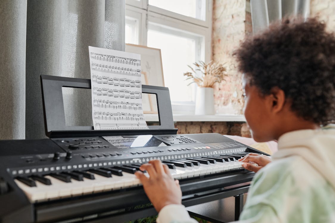 Free Photograph of a Boy Playing a Synthesizer Stock Photo