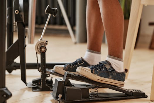Feet wearing blue sneakers on an exercise step. Indoor fitness and exercise equipment.