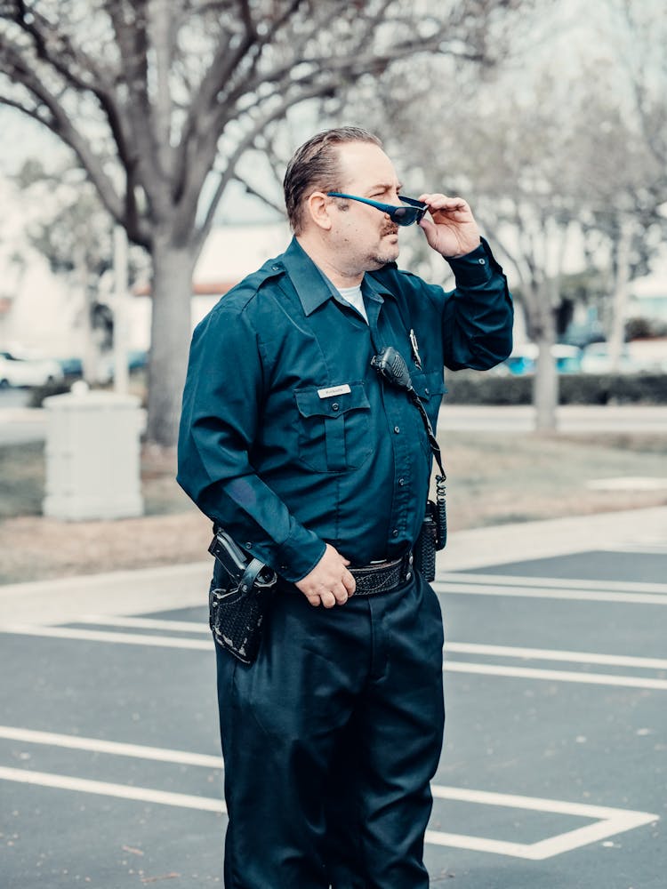 Policeman Wearing Sunglasses Standing On The Road