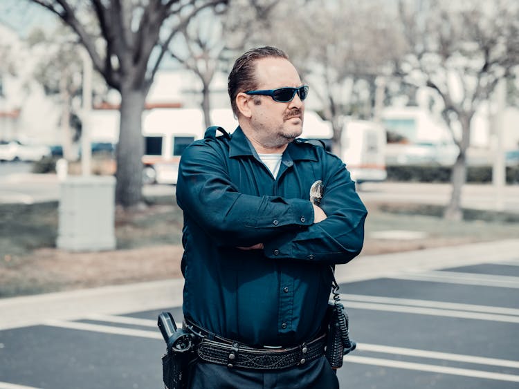 Man In Blue Long Sleeve Shirt Wearing Sunglasses