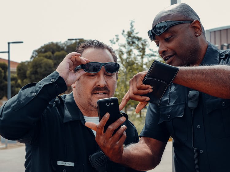 Man In Black Sunglasses Holding Black Smartphone