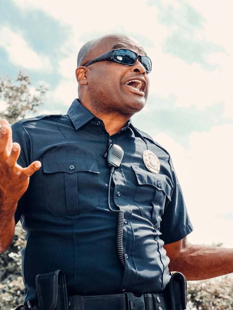 Low-Angle Shot Of A Police Officer Wearing Black Sunglasses