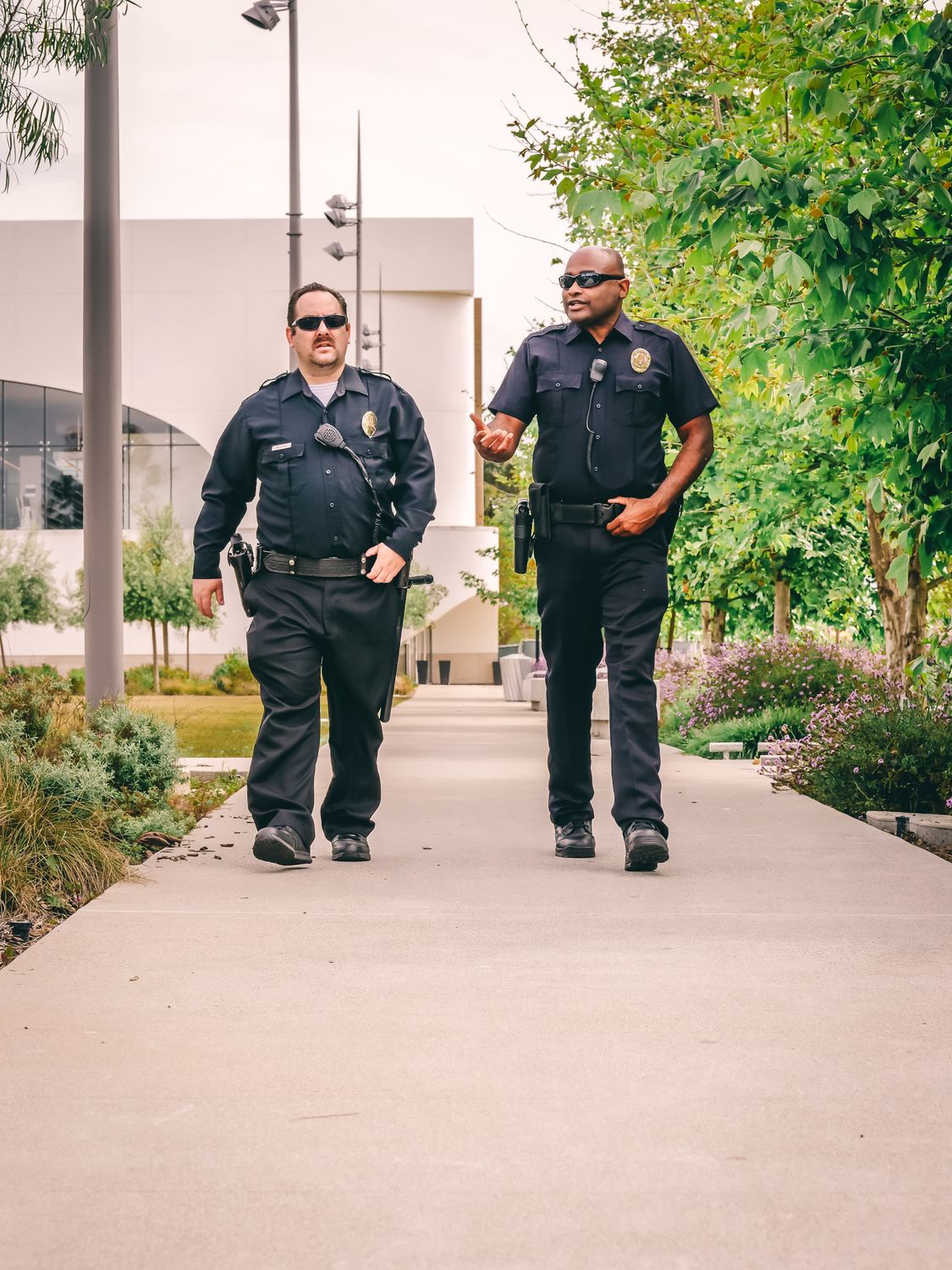 Two Police Officers Walking on the Pathway · Free Stock Photo