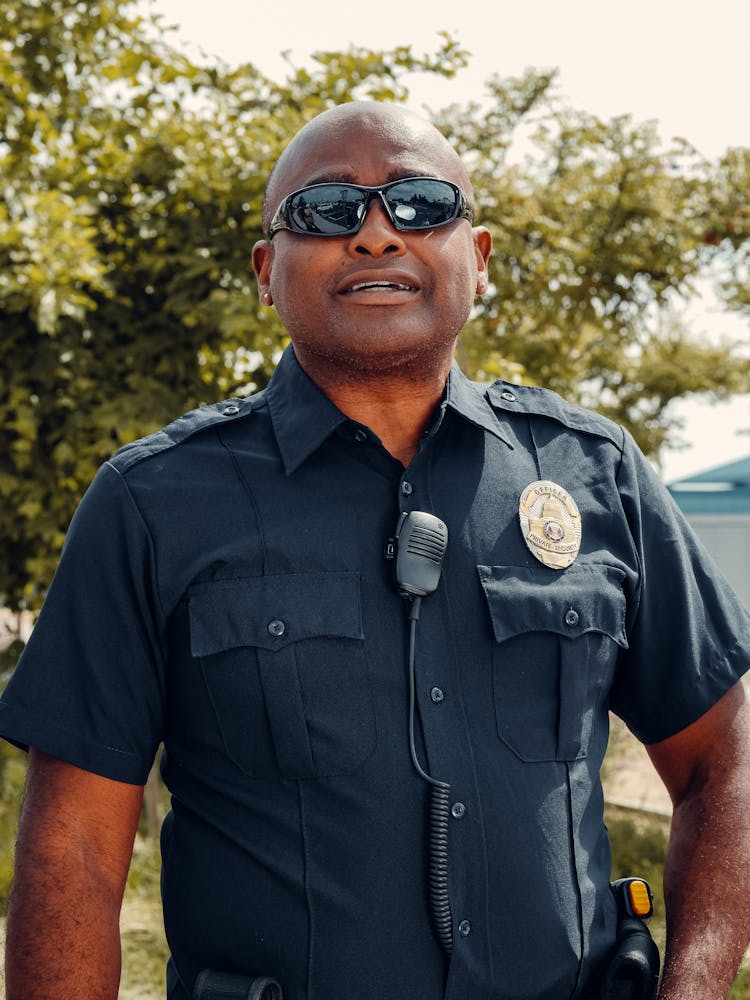 Close-Up Shot Of A Police Officer Wearing Black Sunglasses