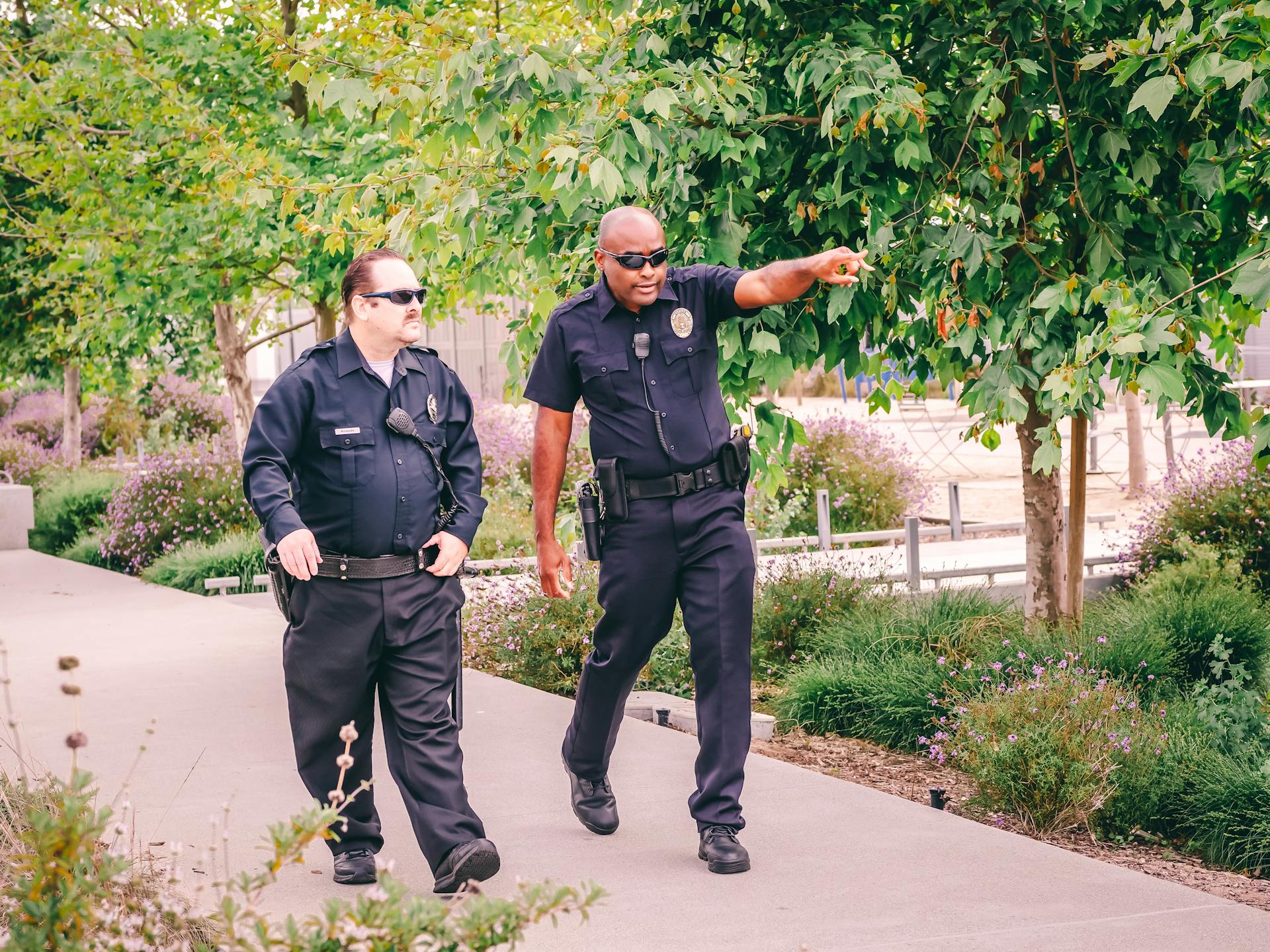 Two Police Officers Walking on the Pathway