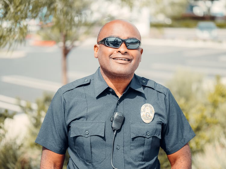 Close-Up Shot Of A Police Officer Wearing Black Sunglasses