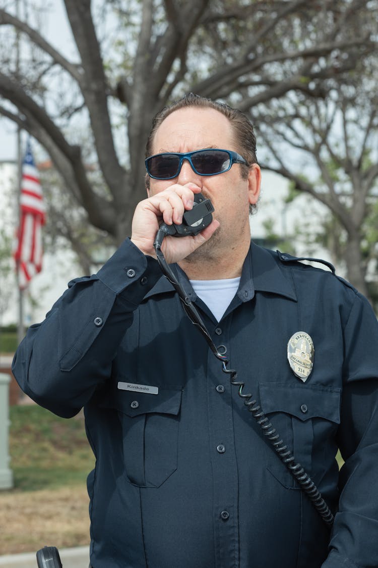 Close-Up Shot Of A Police Officer Wearing Black Sunglasses