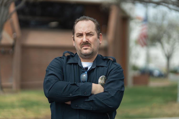 A Man Wearing A Police Uniform