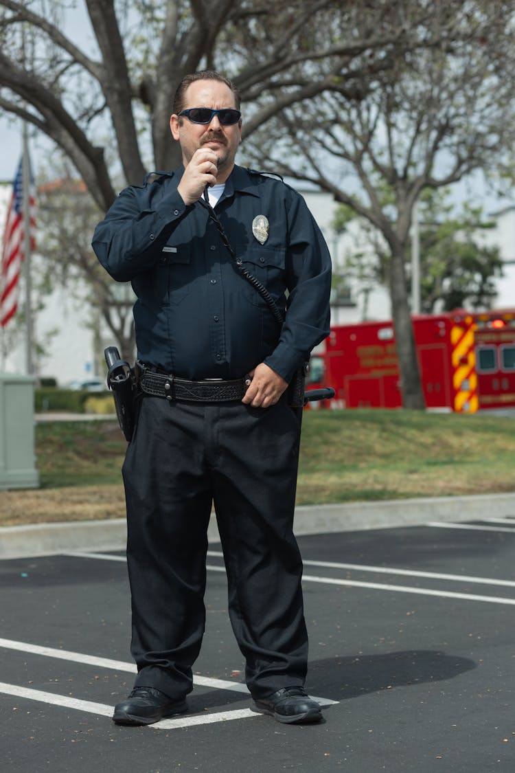 A Police Officer Wearing His Blue Uniform