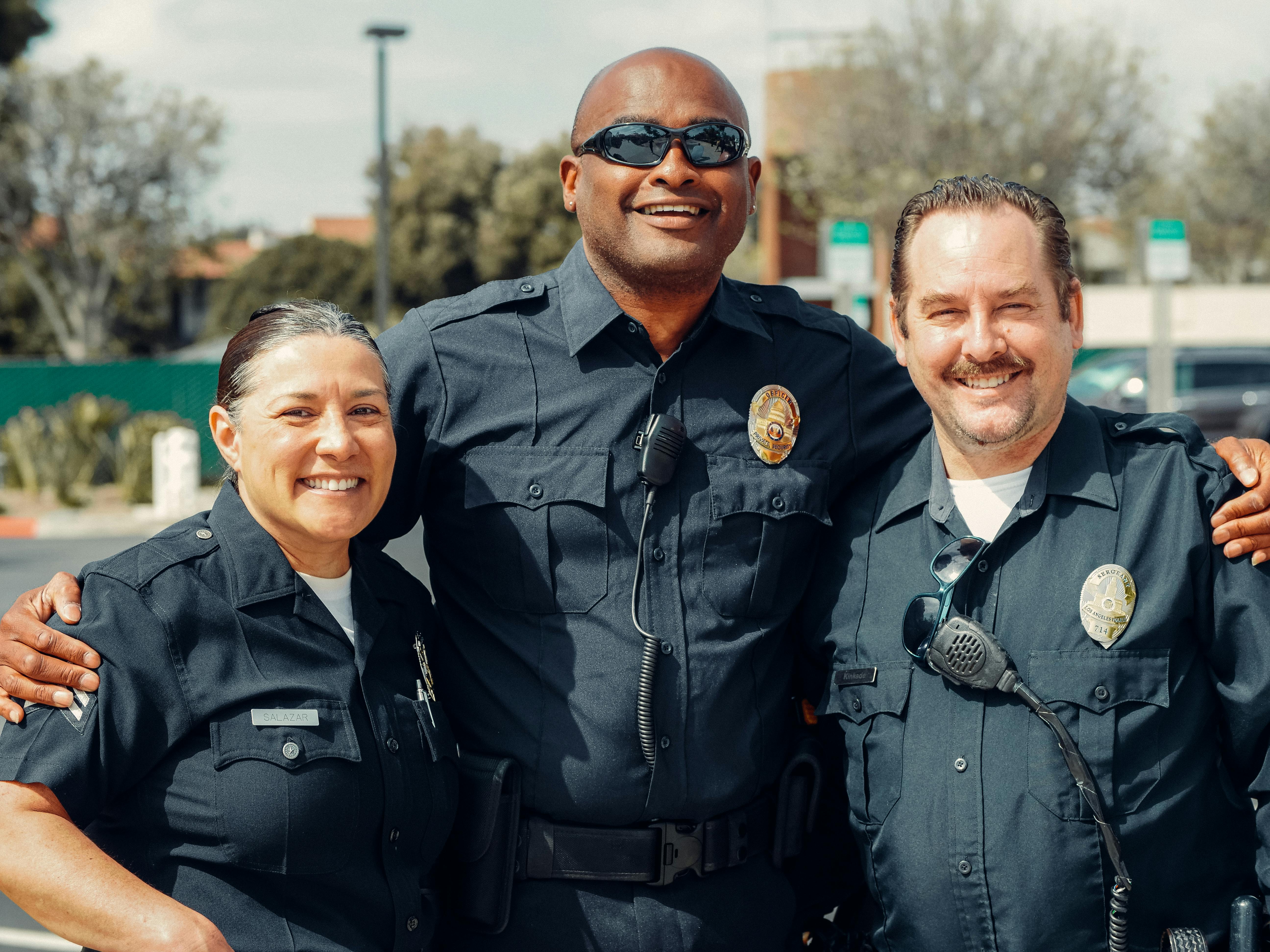 three police officers in blue uniform