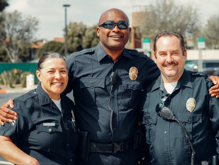 Three Police Officers In Blue Uniform