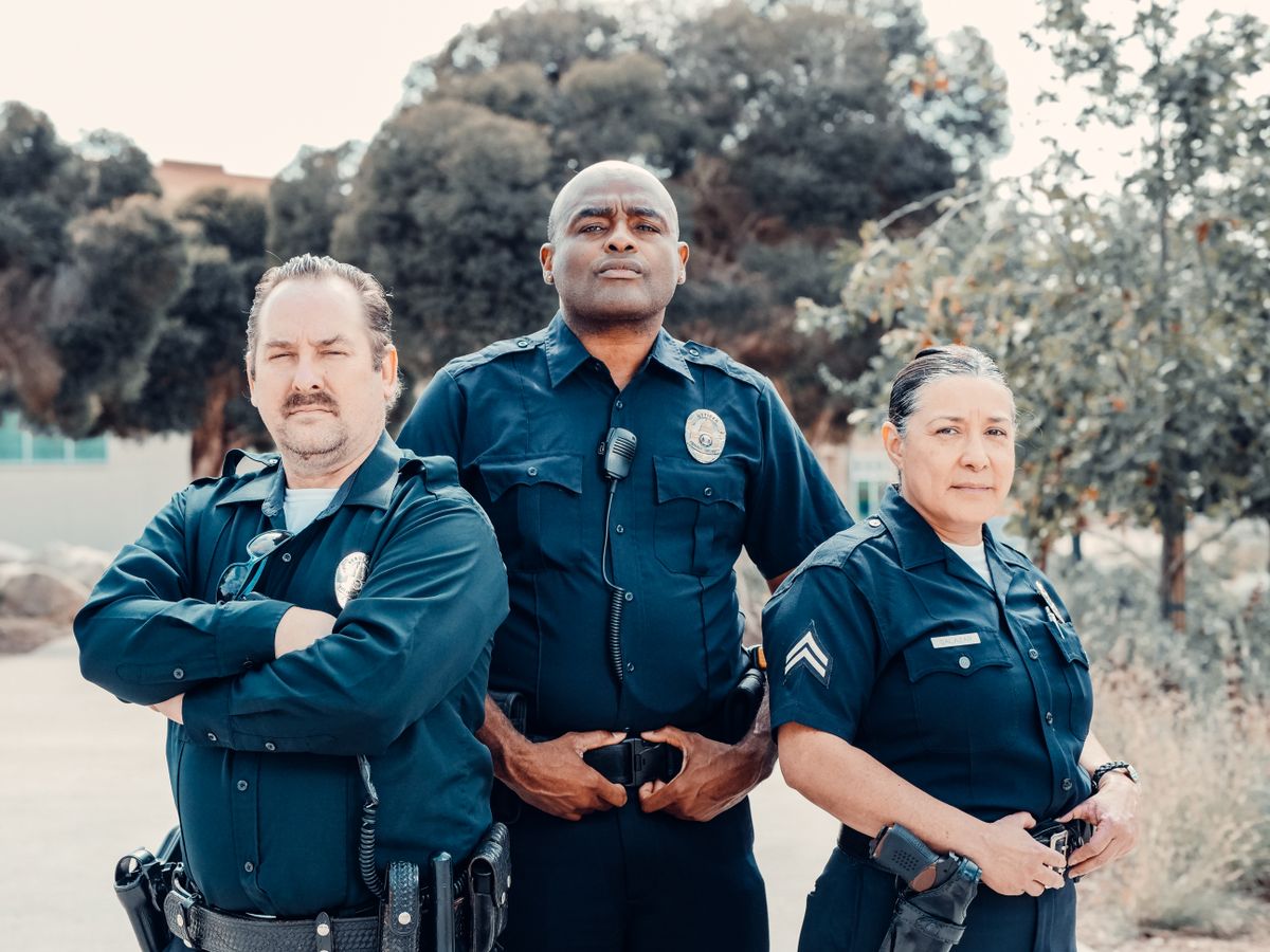 Three uniformed police officers standing together in service dress