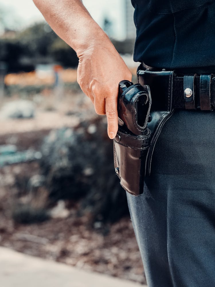 A Police Officer Holding A Gun