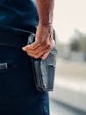 Person Holding a Gun in a Holster