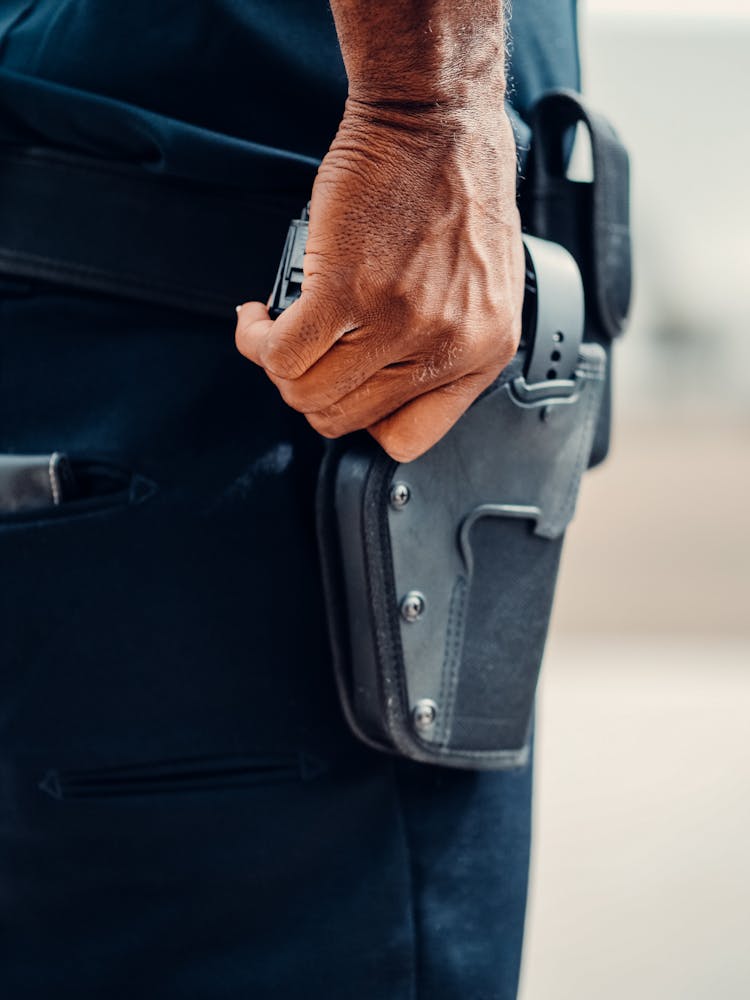 Person Holding A Gun In A Holster