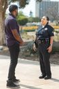 Man in Blue Polo Shirt and Black Pants Walking on Street