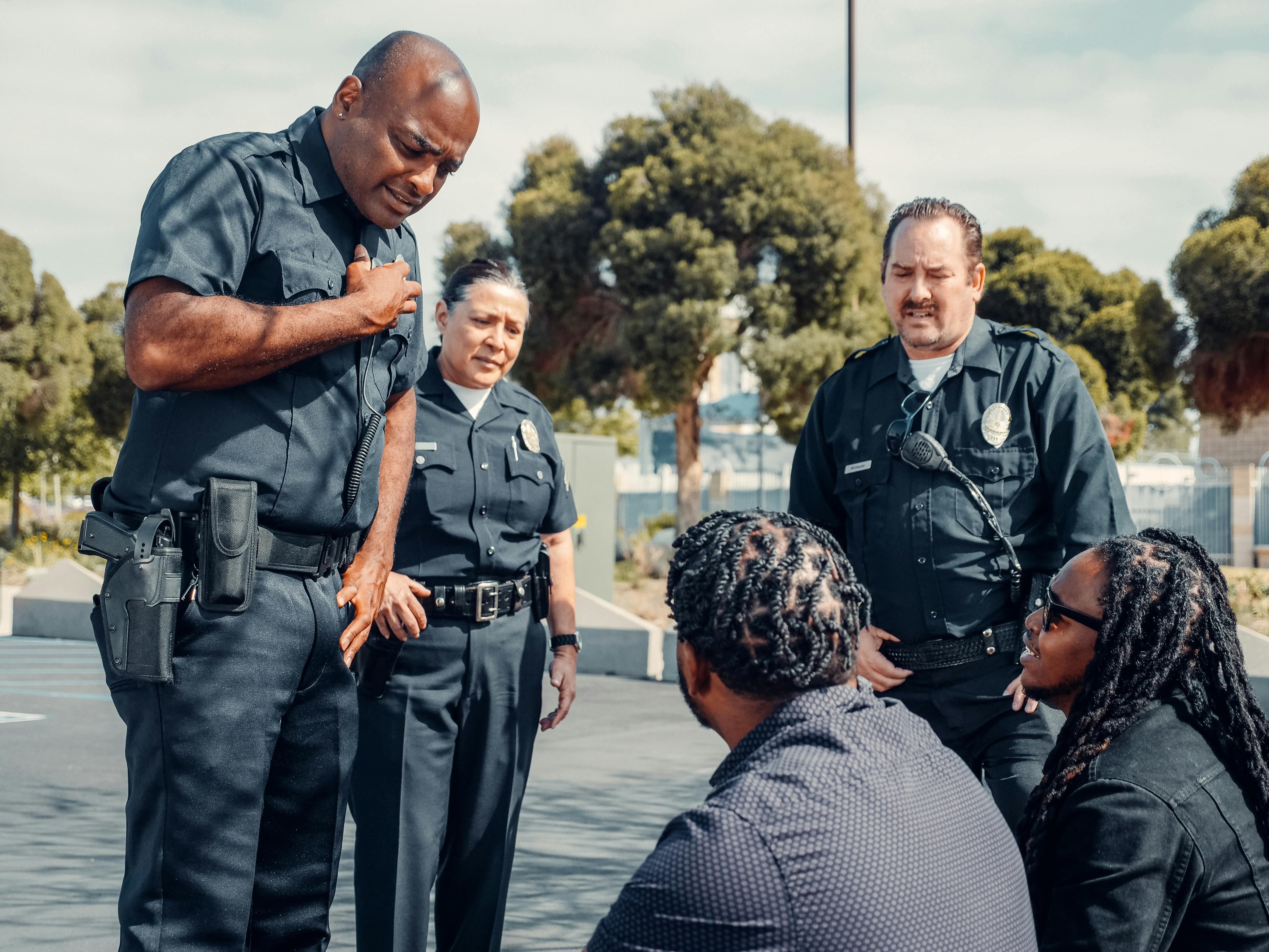 police officers talking to two men on the street