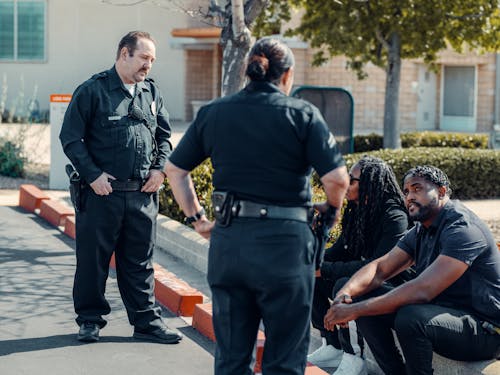 Free Police Officers Talking to Civilians Stock Photo