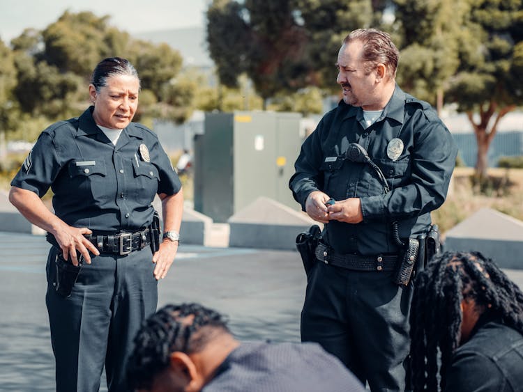 Man And Woman In Black Police Uniform