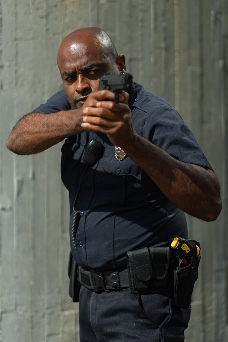 A Policeman Holding A Gun