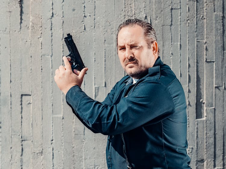 A Cop Holding His Pistol Gun