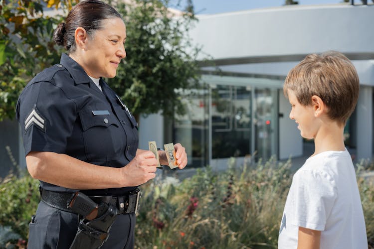 A Police Woman Talking To A Boy