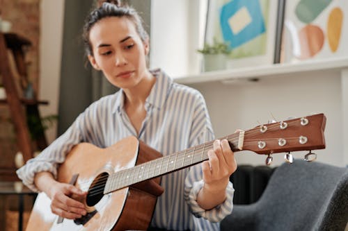 A Woman Playing an Acoustic Guitar