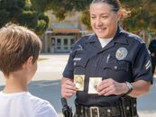 A Policewoman Holding Stickers