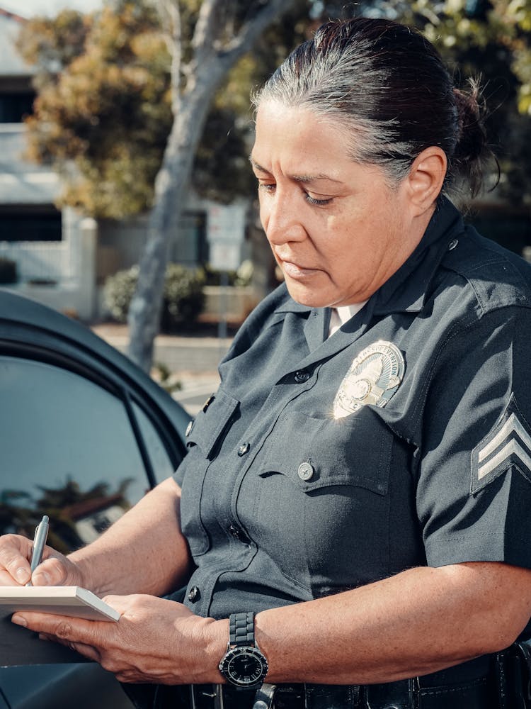 Policewoman Giving A Traffic Violation Ticket