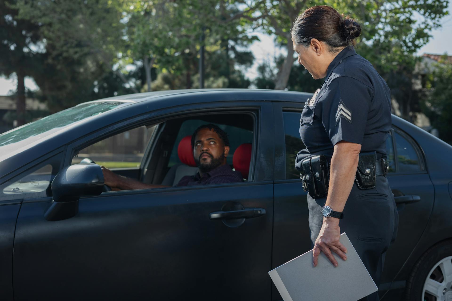 Man Driving While Looking at the Policewoman 