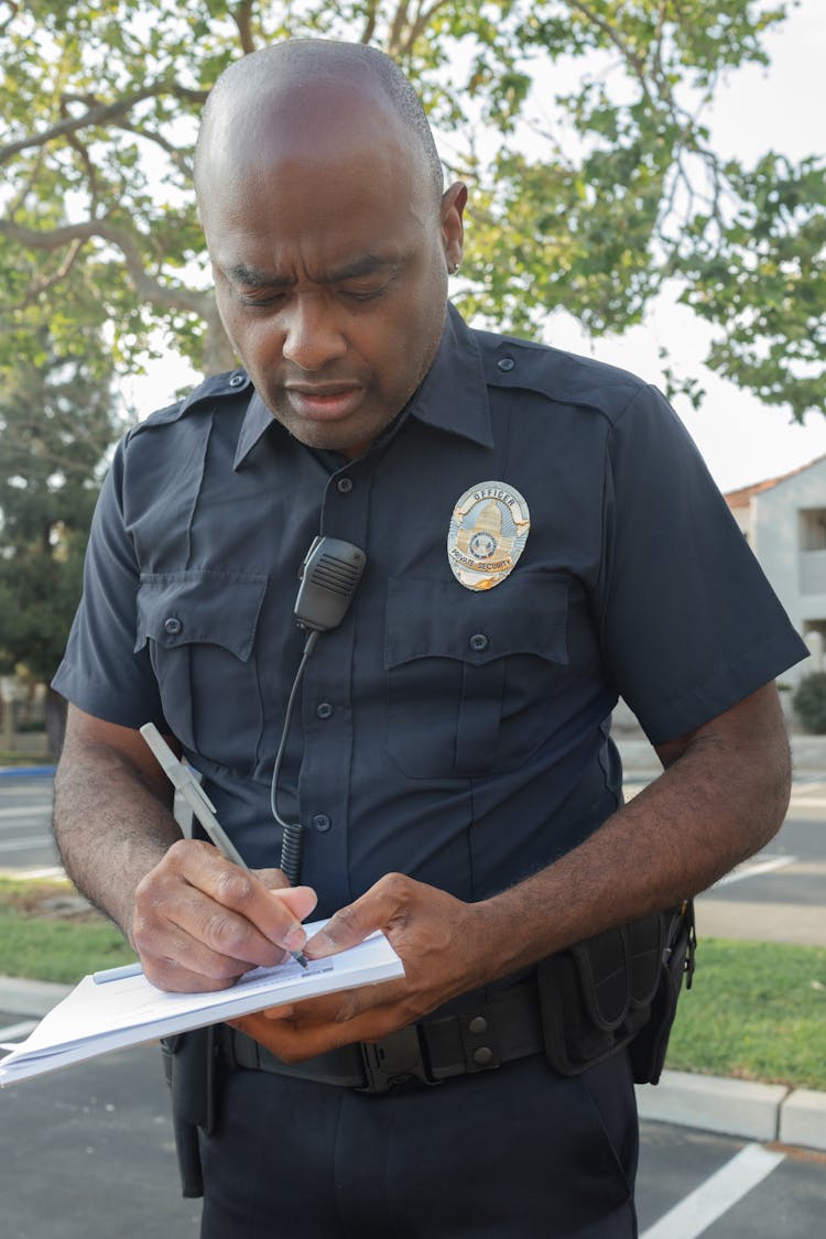 A Police Writing On A Paper