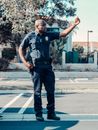 Man in Blue Polo Shirt and Black Pants Standing on Gray Concrete Road