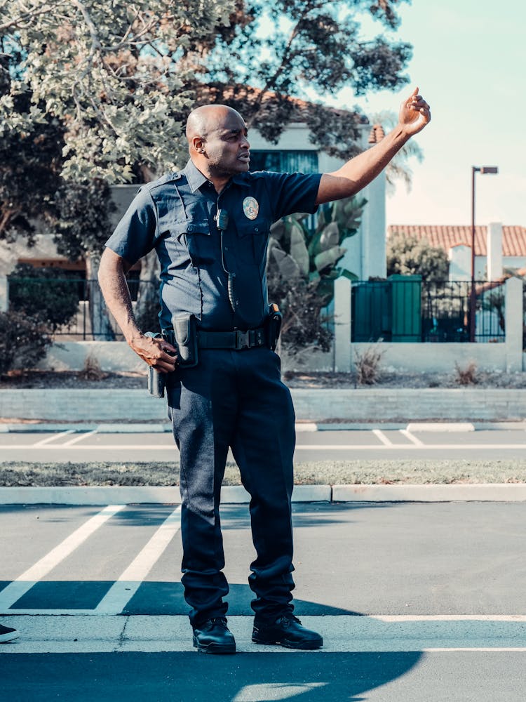 Community Police Officer Standing On The Road